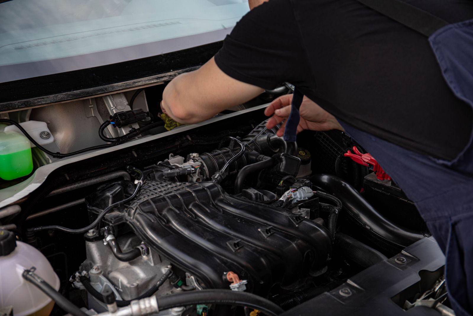 Mechanic working carefully in a car engine bay