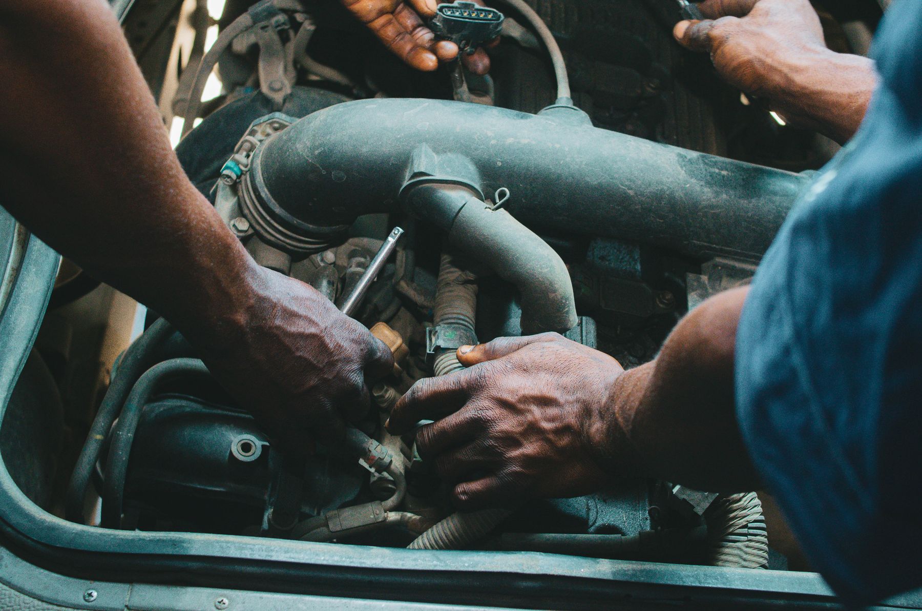 Technicians working together in an engine bay